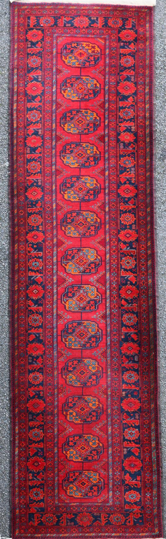 A Bokhara style runner, 9ft 6in by 2ft 9in.